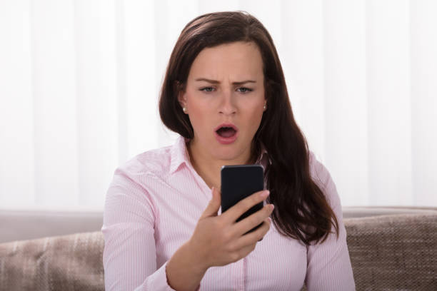 istock Shocked Woman Looking At Mobile Phone 949198728