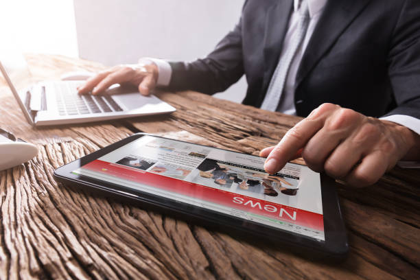 istock Businessman Reading News On Digital Tablet 949198962