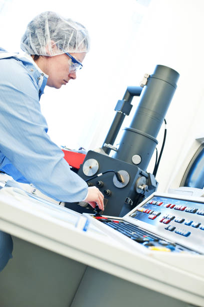 istock Research And Development: Female Scientist Working On The Console Of A High Resolution Scanning Microscope (SEM) Laboratory / Cleanroom 949202518