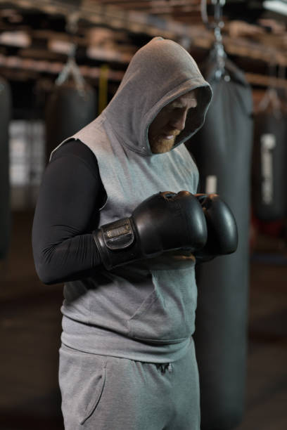 istock Middle Aged Redhead Handsome Boxer Fighter training with Heavy bag in Gym Setting 949202782
