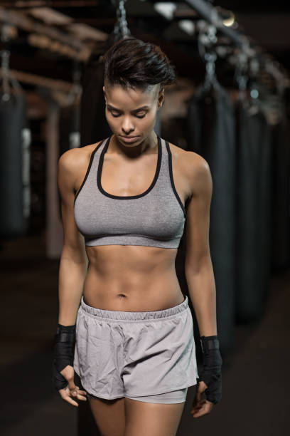 istock Beautiful mixed race female Boxer Fighter training hard in Gym Setting 949202910