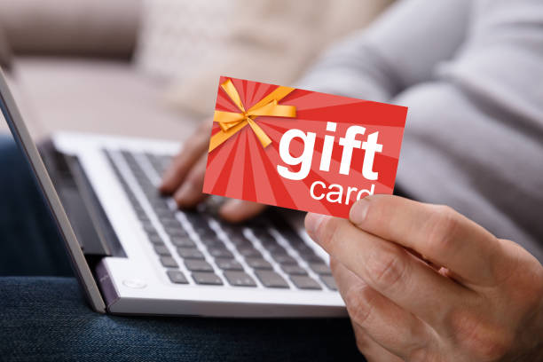istock Person Working On Laptop Holding Gift Card 949203064