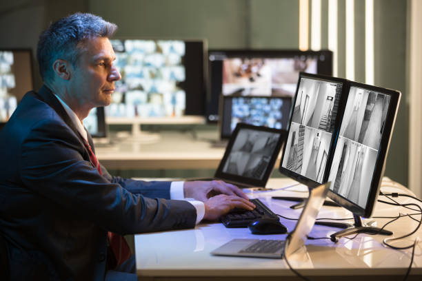 istock Businessman Looking At CCTV Camera Footage 949203150