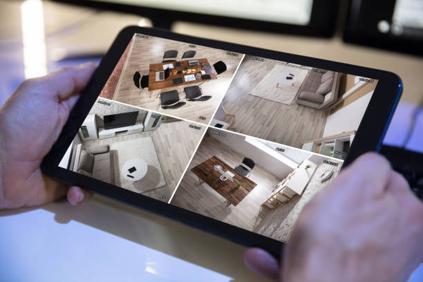 istock Businessman Looking At CCTV Camera Footage On Digital Tablet 949206588