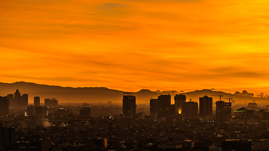 Orange sunset view of a city that looks like a painting