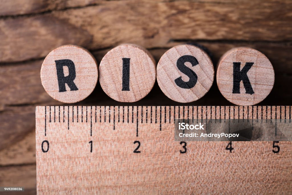 Wooden Blocks With Risk Text And Ruler High Angle View Of Wooden Blocks With Risk Text And Ruler Risk Stock Photo