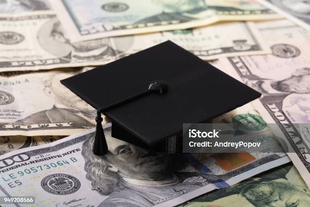 Graduation Cap On Dollar Banknotes Stock Photo - Download Image Now - Studying, Currency, University