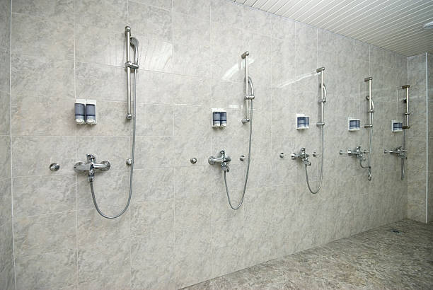 Modern shower room with silver showers and dispensers stock photo