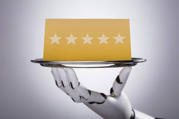 Robot Holding Plate With Star Rating Close-up Of A Robotic Hand Holding Plate With Star Rating On Grey Background domestic staff stock pictures, royalty-free photos & images