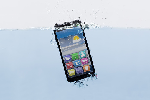 Close-up Of A New Black Mobile Phone Submerged In Water