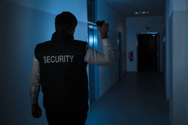istock Security Guard Standing In Corridor Of The Building 949212702
