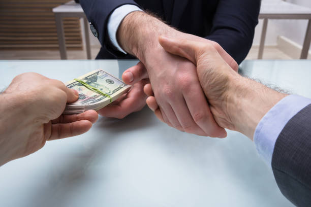 istock Two Business Partners Shaking Hand At Workplace 949212934