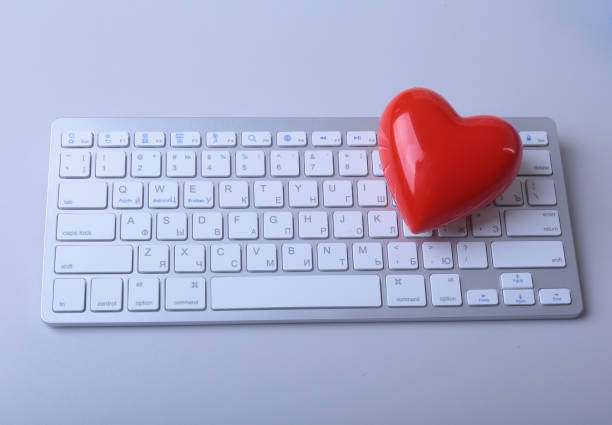 istock Small red heart on keyboard. Internet dating concept 949215370
