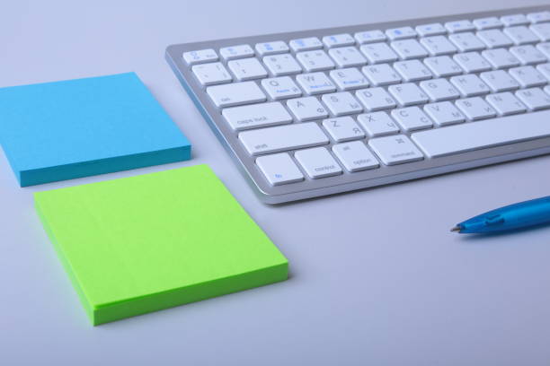 istock Office desk with keyboard and stikers, papers 949215444