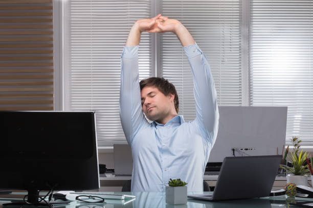 istock Tired Businessman Stretching His Arms 949215480