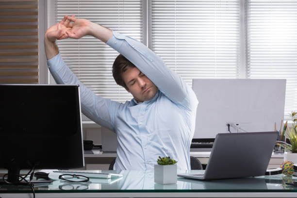 istock Tired Businessman Stretching His Arms 949215502