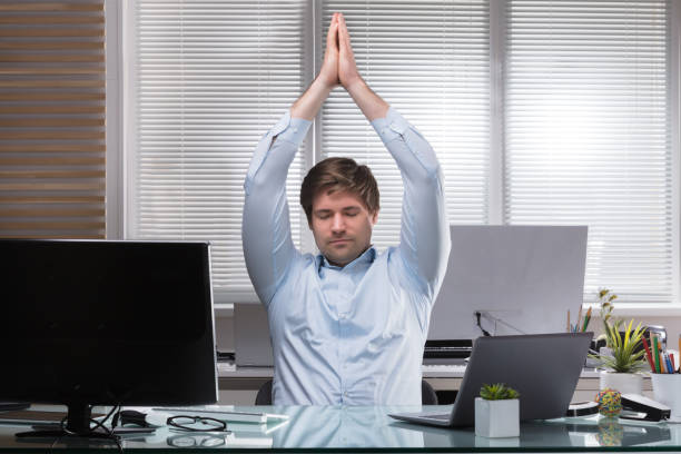 istock Tired Businessman Stretching His Arms 949215508