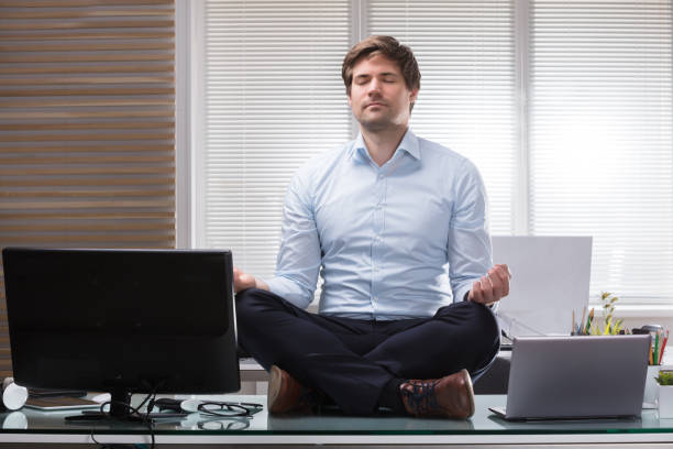 istock Businessman Meditating In Office 949215524