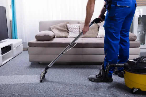 Photo of Janitor Cleaning Carpet