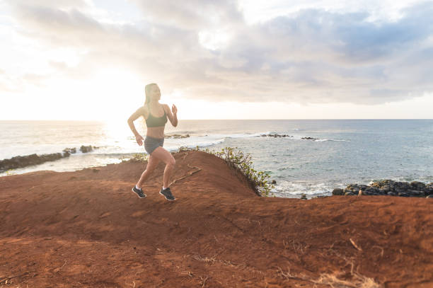 istock Solo female jogger on Hawaii coastline 949216564