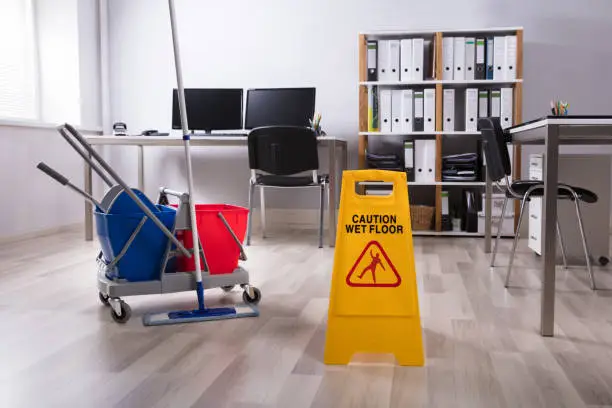 Wet Floor Caution Sign And Cleaning Equipments On Floor