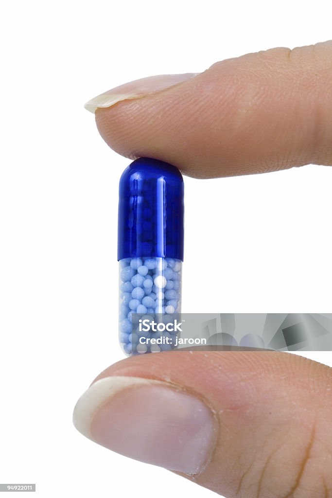capsule between two fingers  Birth Control Pill Stock Photo