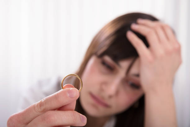 istock Woman Holding Wedding Ring 949220418
