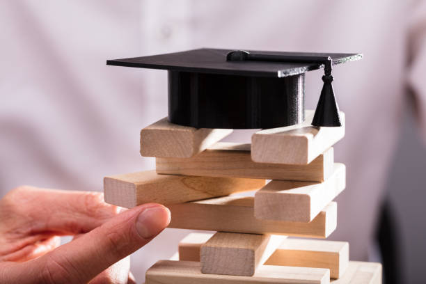 istock Graduation Hat Over Stacked Wooden Blocks 949220830