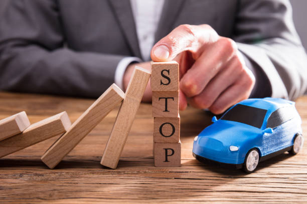 istock Falling Dominos Stopped By Human Finger On Wooden Blocks 949223074