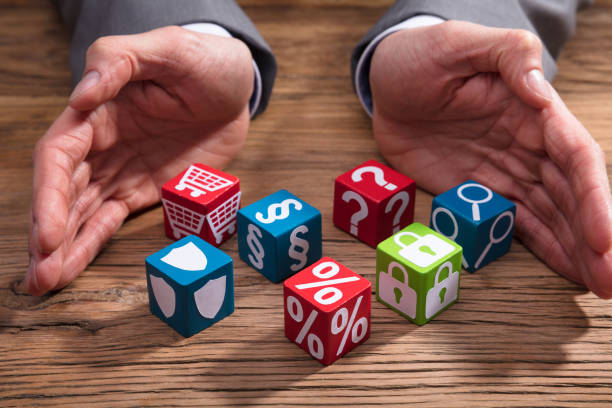 istock Businessperson Protecting Square Shaped Blocks 949223180