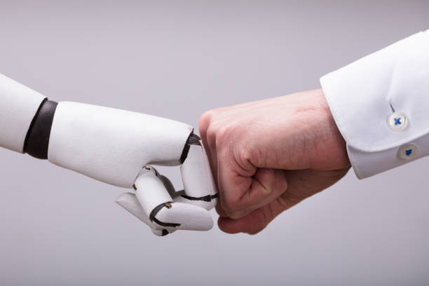 istock Robot And Human Hand Making Fist Bump 949223490