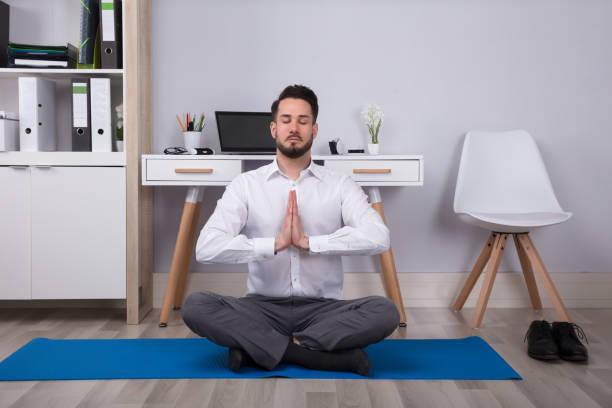 istock Businessman Meditating In Office 949223616