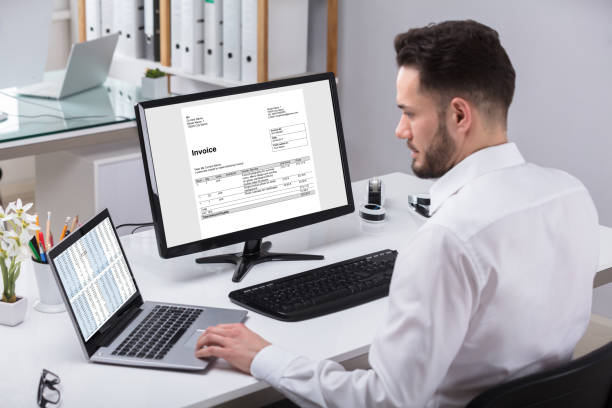 Young Businessman Using Laptop Young Businessman Using Laptop With Computer Screen Showing Invoice bowie seamount stock pictures, royalty-free photos & images