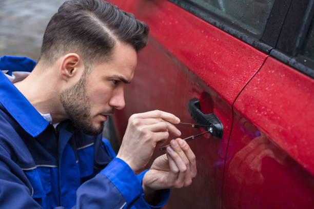 Man Opening Car Door With Lockpicker Young Man Opening Red Car Door With Lockpicker car door photos stock pictures, royalty-free photos & images