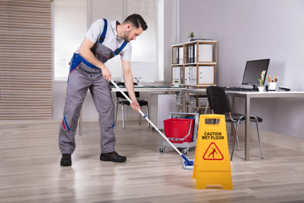 istock Man Cleaning Hardwood Floor In Office 949224564