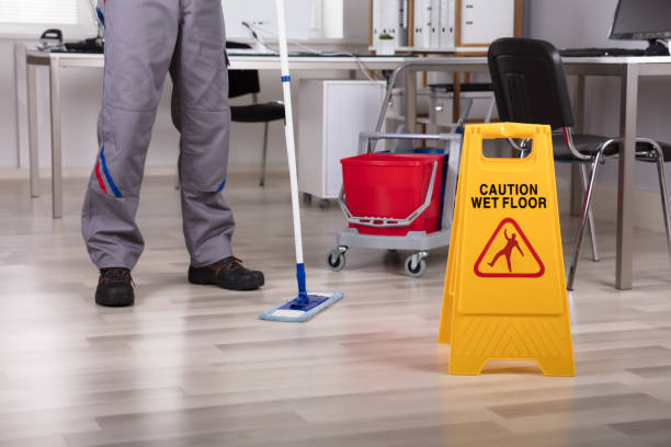 istock Cleaner Standing With Mop And Caution Wet Floor Sign 949224576