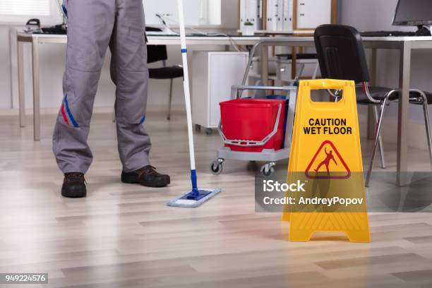 https://media.istockphoto.com/id/949224576/photo/cleaner-standing-with-mop-and-caution-wet-floor-sign.jpg?s=612x612&w=is&k=20&c=r5kgYjpQIlKTe7PCn98JjcL_Fhh5u_5e8Y4zT3fGqRA=