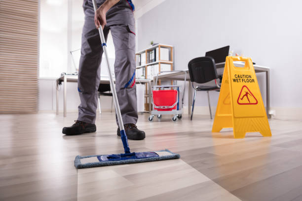 istock Male Janitor Cleaning Floor In Office 949224618