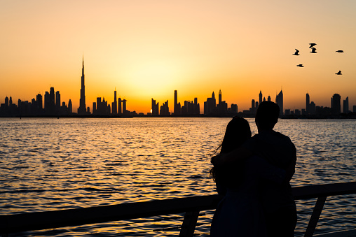 Couple enjoying panoramic view of Dubai at sunset