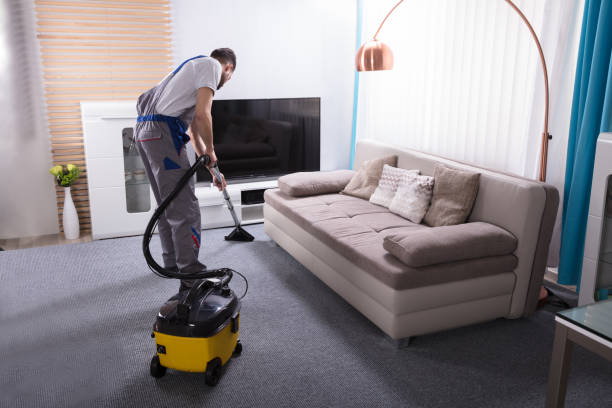 istock Janitor Cleaning Carpet With Vacuum Cleaner 949224918