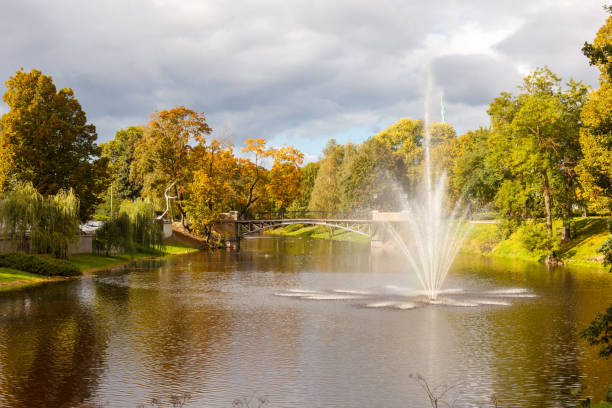 Bridge, fountain and river landscape. Natural summer background pattern.