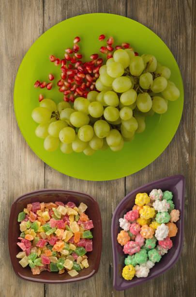 grapes, pomegranate on a wooden background. grapes, pomegranate on a plate