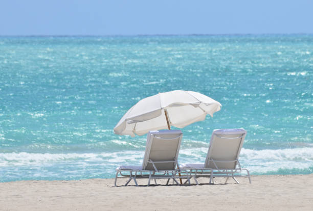 Tropical beach with chair and parasol