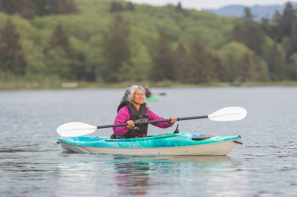 istock Senior ethnic woman kayaking solo on the river 949227724