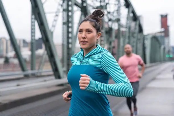 Photo of A group of co-ed runners goes for a training run in the city