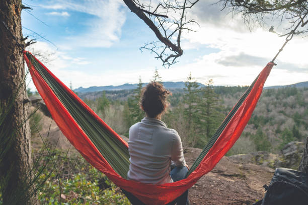 istock A young woman relaxes in a hammock in the forest 949235606