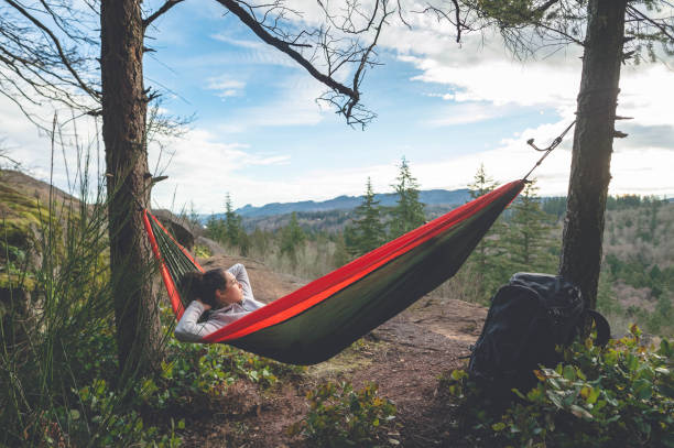 istock A young woman relaxes in a hammock in the forest 949235612