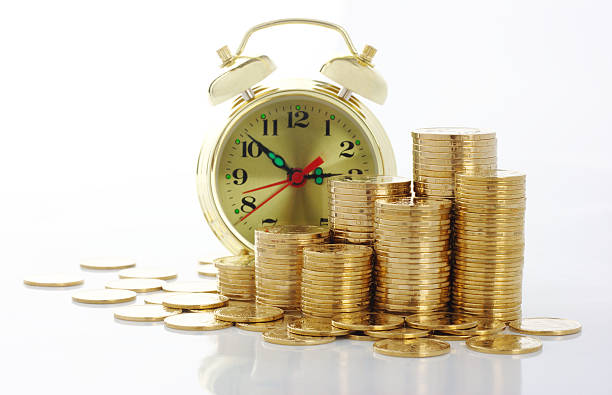 istock Clock and coins, time is money concept 94923566