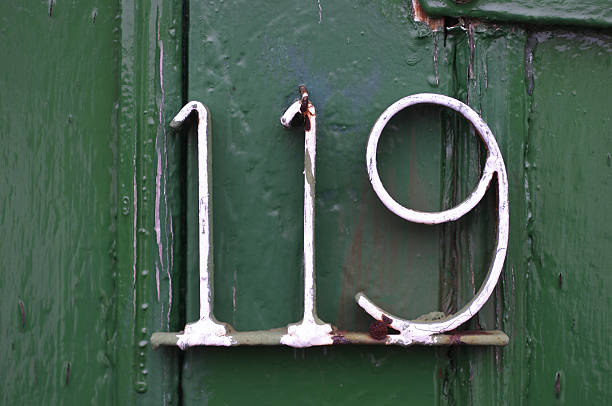 DIY number on a gate, plenty of character (rust, paint, 3D).
