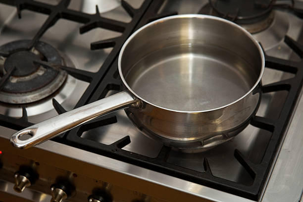 istock pan of water heating on a gas stove. 94923809